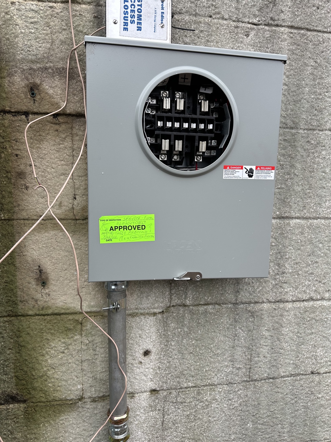 Green municipal approval sticker on electrical meter equipment