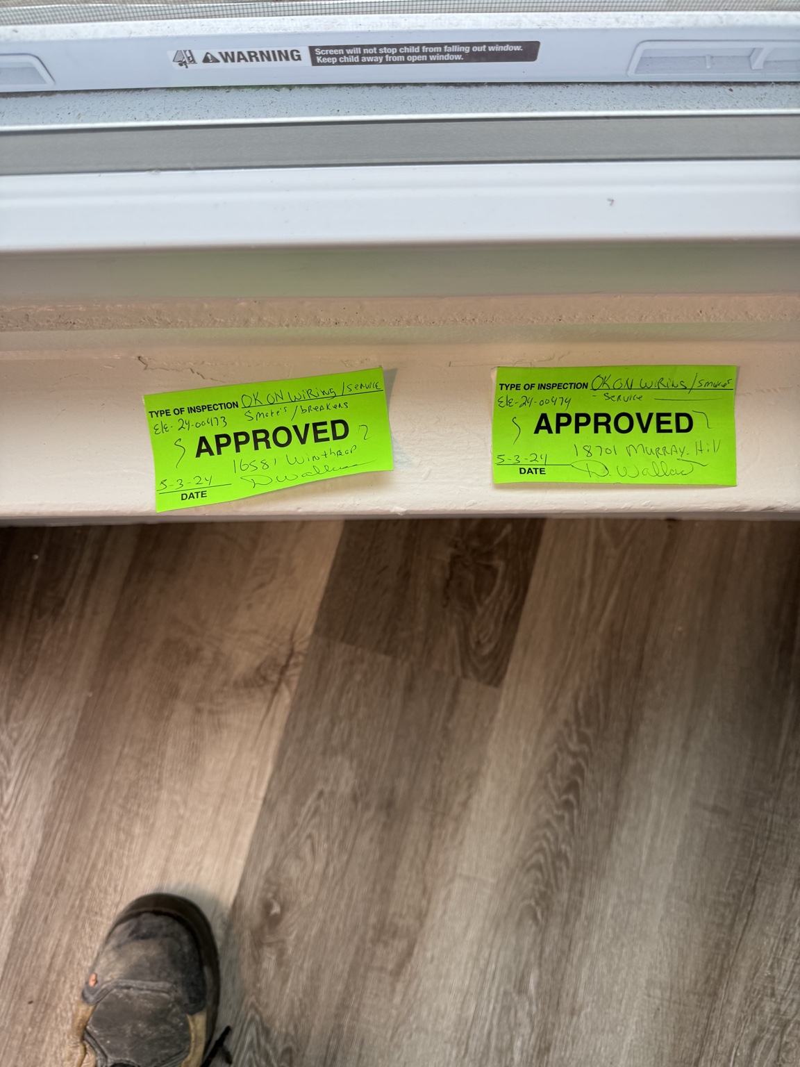 Two green approved electrical inspection stickers